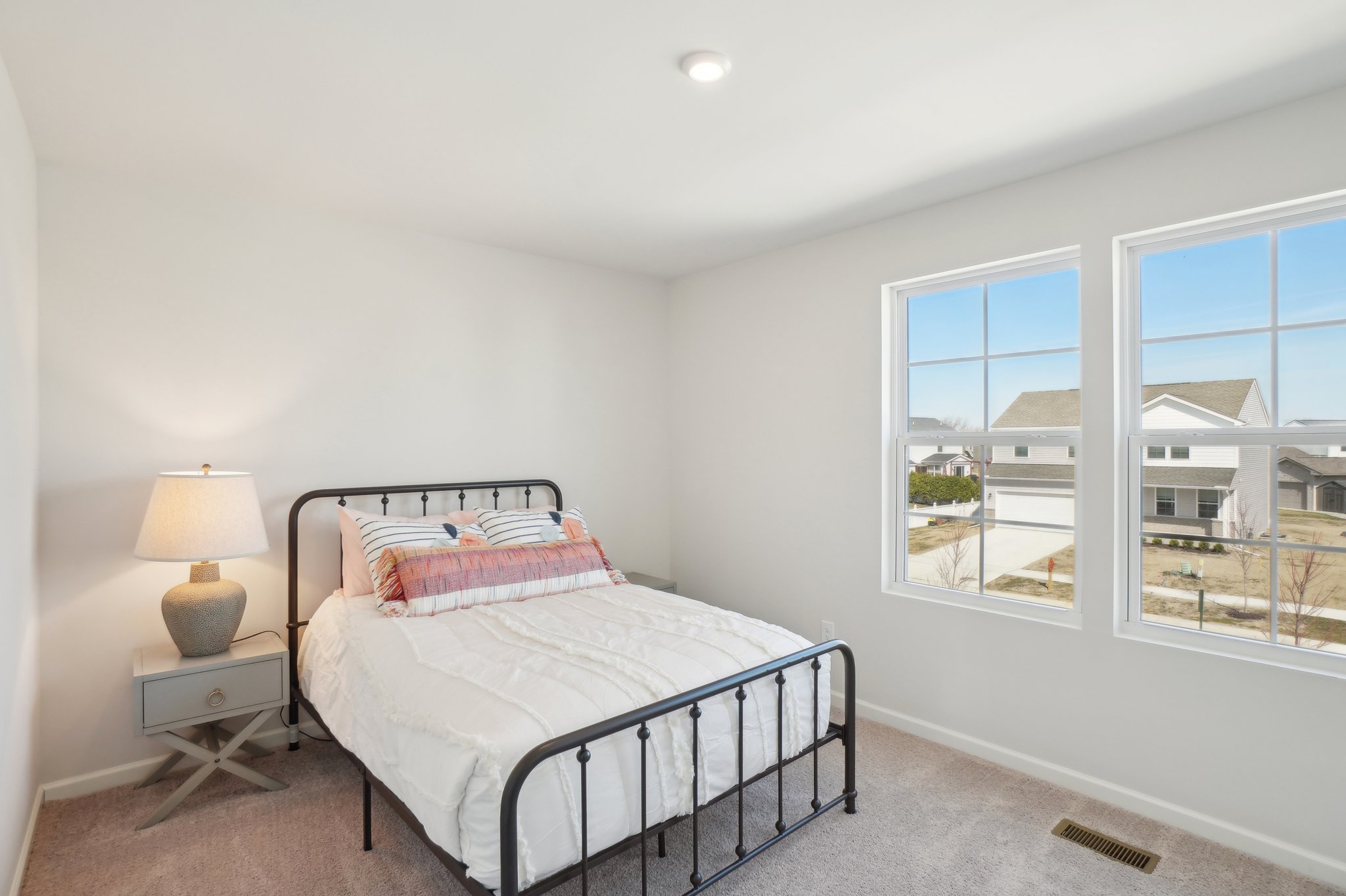 A bedroom with a bed and a window.