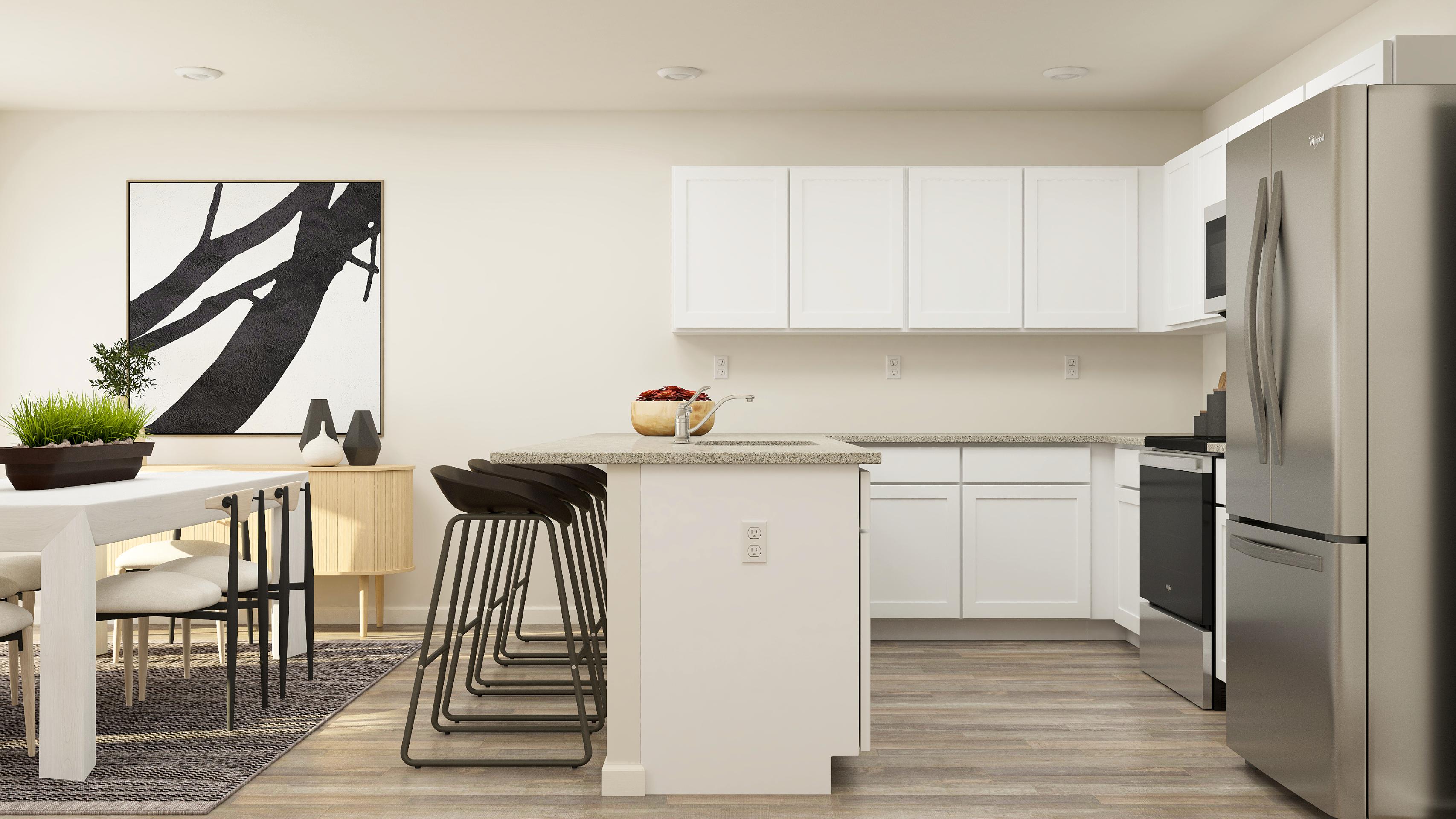 A kitchen with white cabinets.
