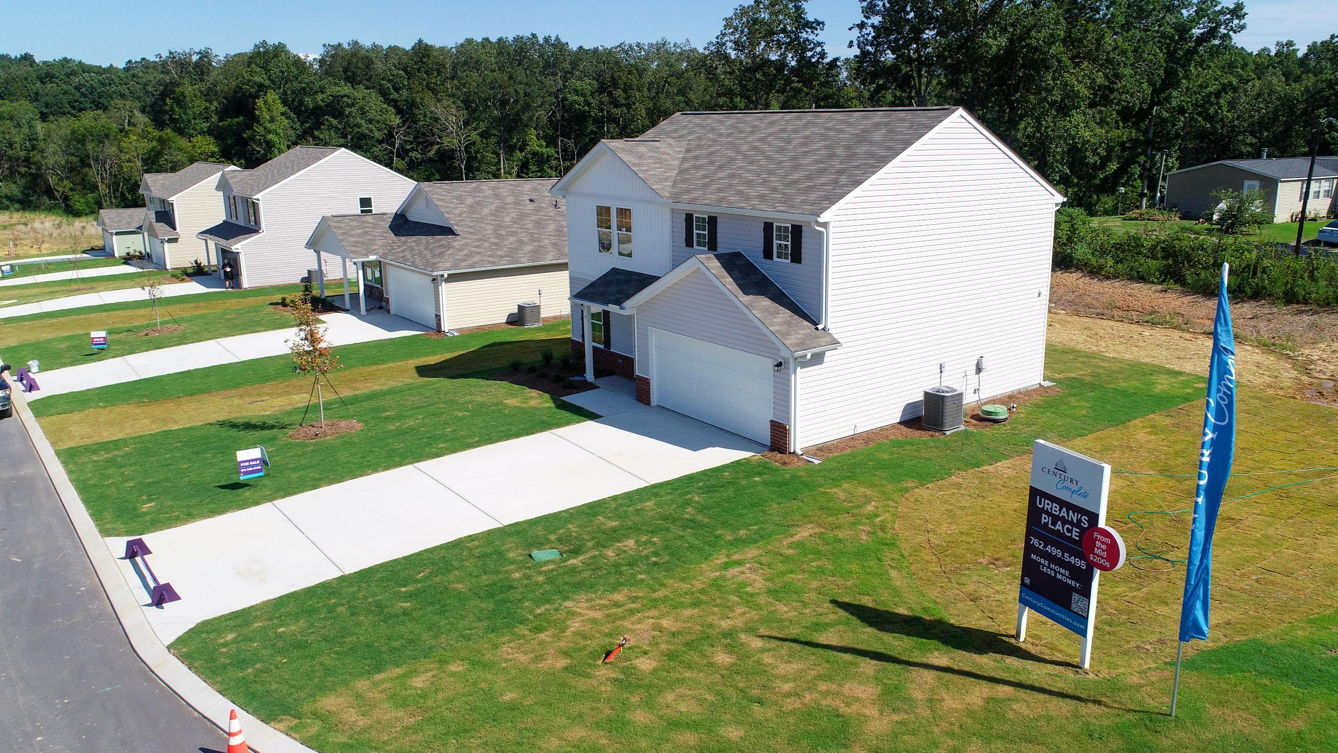 A house with a lawn and a flag in front of it.