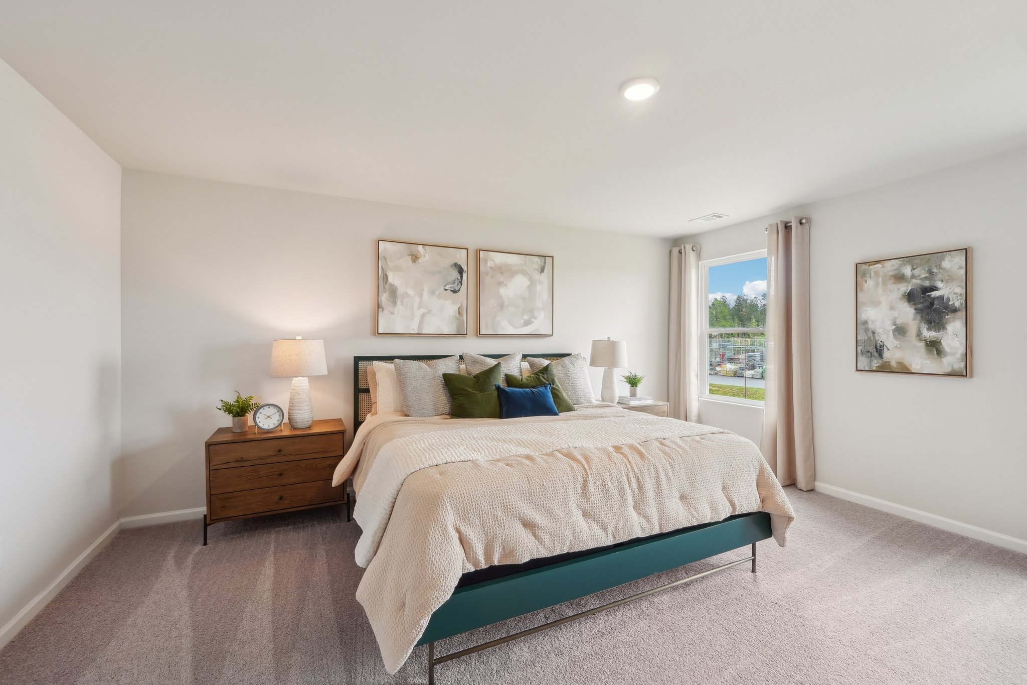 A bedroom with a bed and lamps.