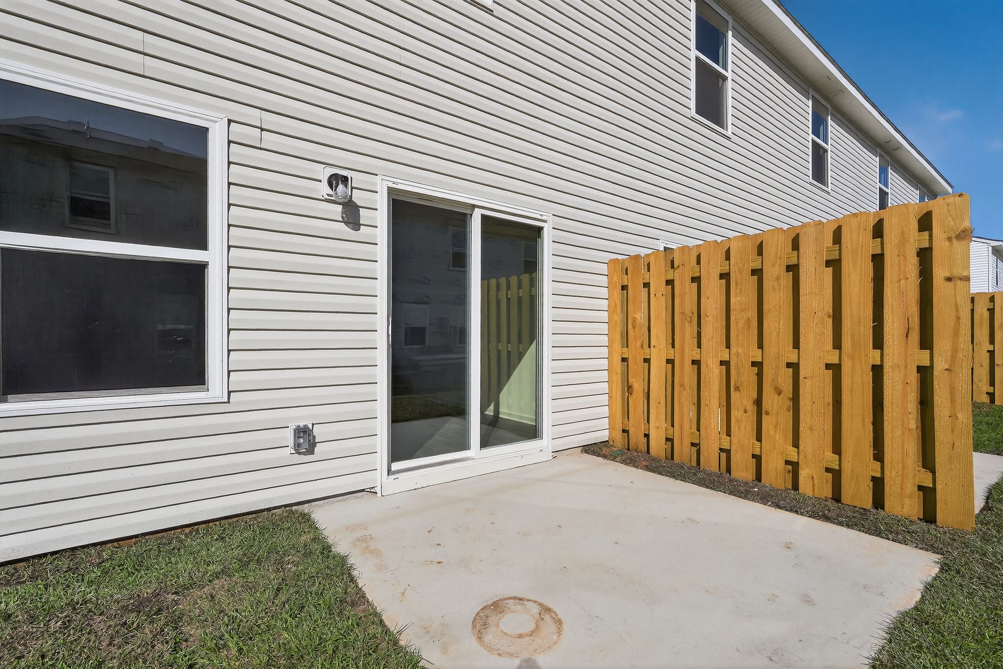 A white house with a wood fence.