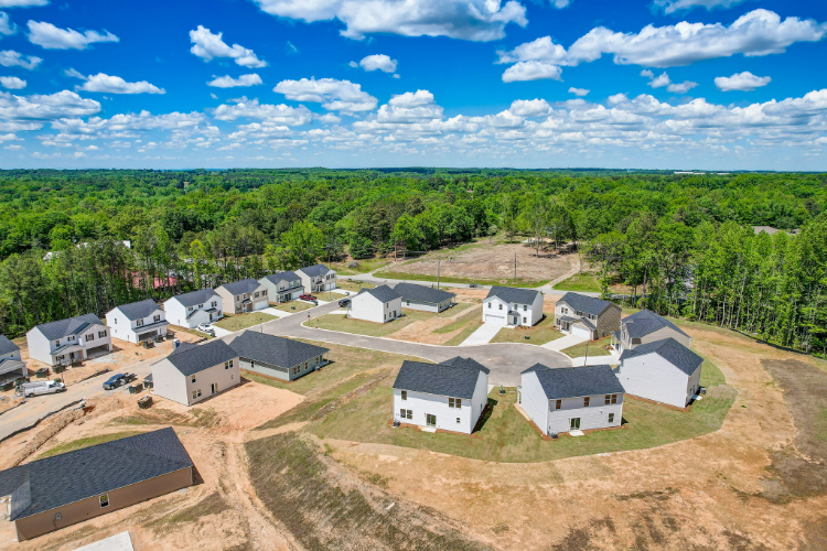 A group of houses in a wooded area.